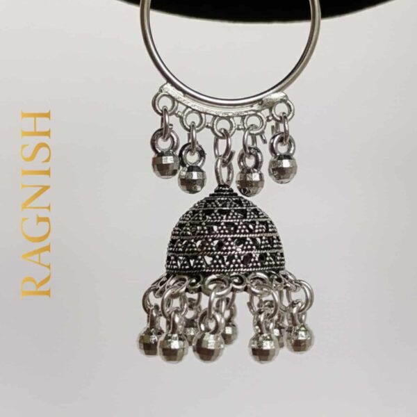 Close-up of a single RAGNISH handcrafted Jhumka earring, showcasing detailed craftsmanship and dangling beads.
