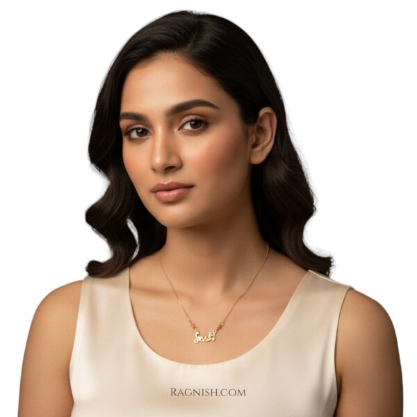 Fine jewelry product image: gold-plated script necklace with a box chain, highlighting the craftsmanship and crystal embellishment.