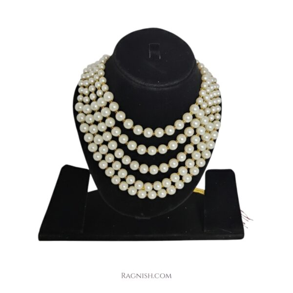 Close-up of five-strand pearl choker on model wearing luxury RAGNISH jewelry
