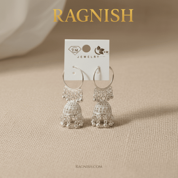 RAGNISH silver jhumka hoop earrings on a light, neutral-toned fabric, showcasing intricate filigree and beadwork.