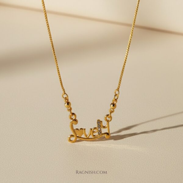 RAGNISH "Lovely" script pendant necklace in 18k gold-plated sterling silver with sparkling pavé crystal detail, close-up shot on a light background.