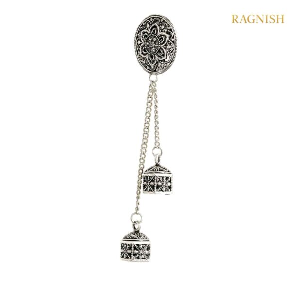 Close-up of a luxurious RAGNISH oxidized silver earcuff featuring a floral stud and two ornate bell tassels.