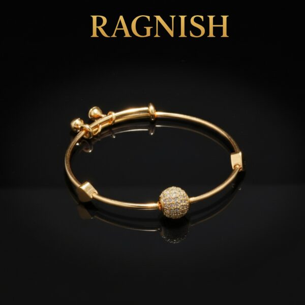 Close-up of two RAGNISH bangles showing heart charms and sparkling solitaire beads.