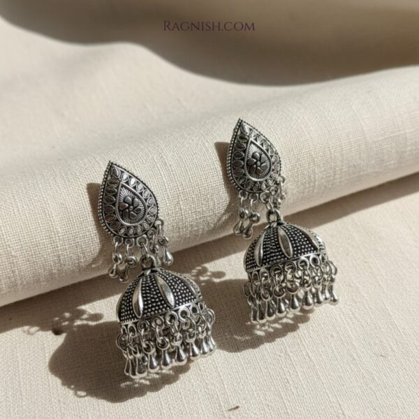 Pair of RAGNISH antique silver-finish jhumka earrings for women, displayed on a clean white background.