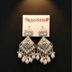 RAGNISH luxury pearl and kundan dangler earrings on white card against black background.