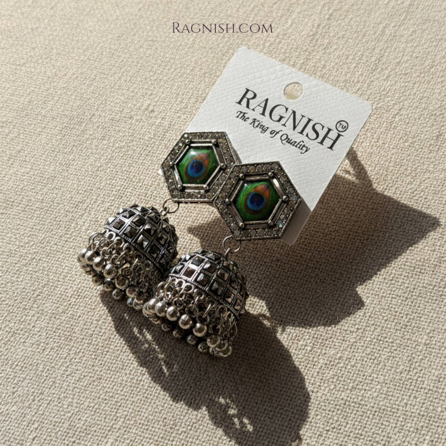 Detailed Close-up of RAGNISH Peacock Jhumkas for E-commerce Product Display.